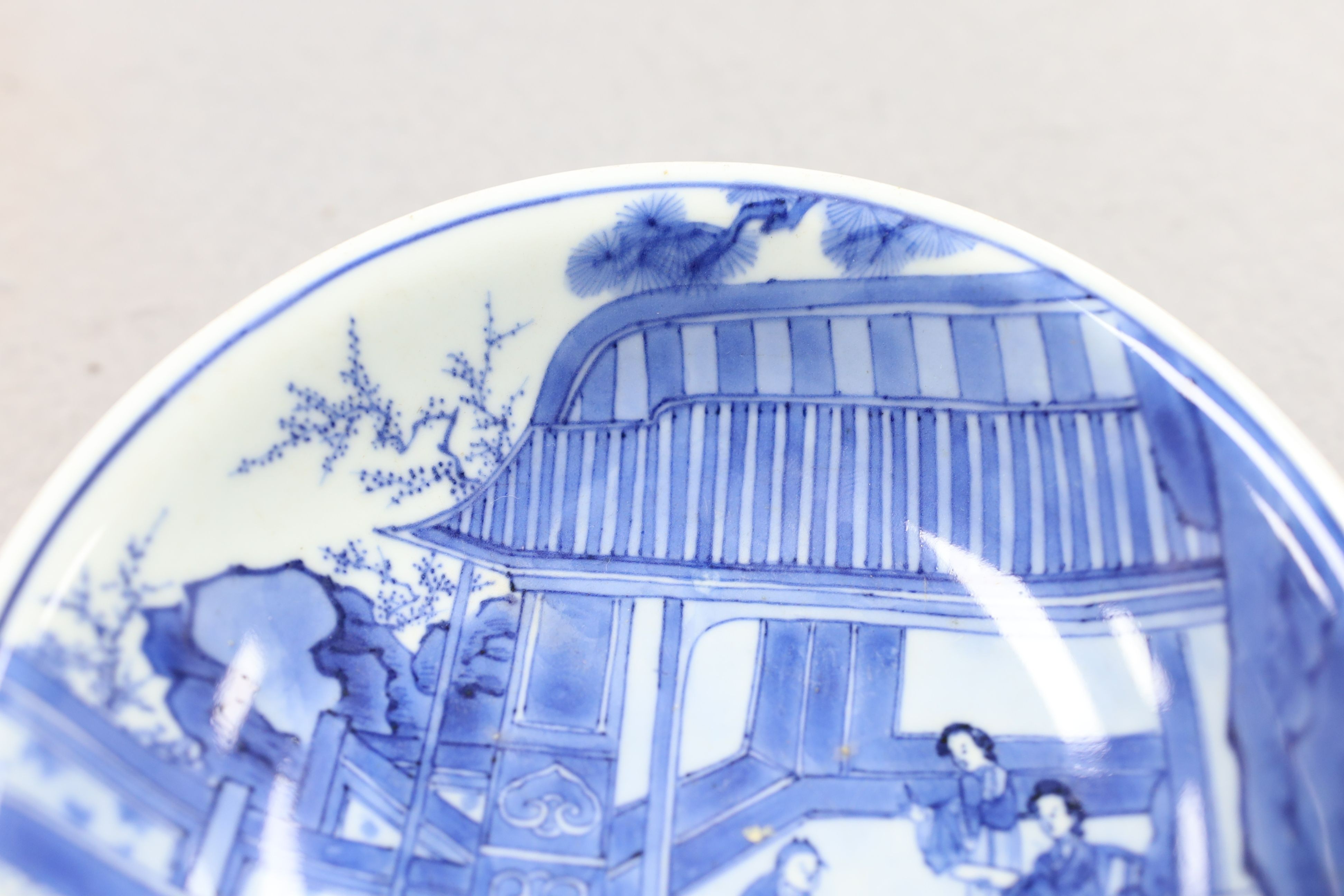 NB BOTH WITH HAIRLINE CRACKS A pair of Chinese blue and white small dishes, Kangxi six character marks and of the period (1662-1722), 15.7cm and 15.8cm diameter, foot later pierced, hairline cracks